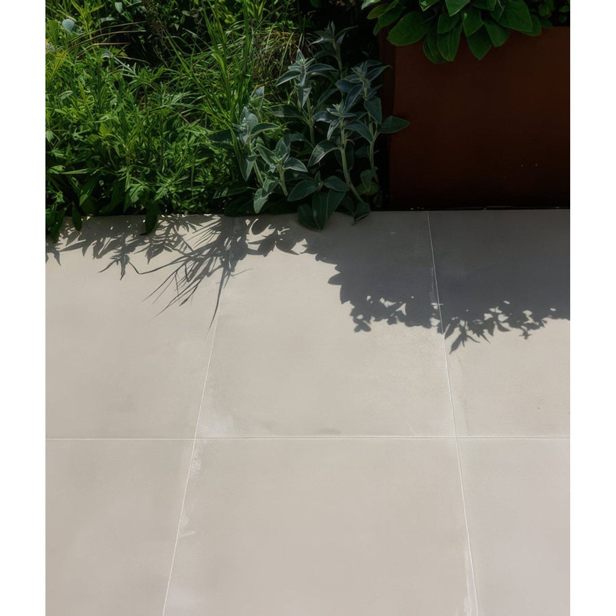 Beige béton chic porcelain paving floor tiles with a smooth glossy finish and textured surface