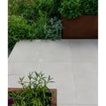 Light gray square porcelain patio tiles with smooth matte finish from béton chic paving textured collection