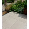 Beige rectangular beton chic porcelain paving tiles with textured surface and subtle gray grout lines for patios