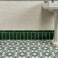 Brompton porcelain greenwich white glossy subway tiles with bold green porcelain border tile at the base of the wall