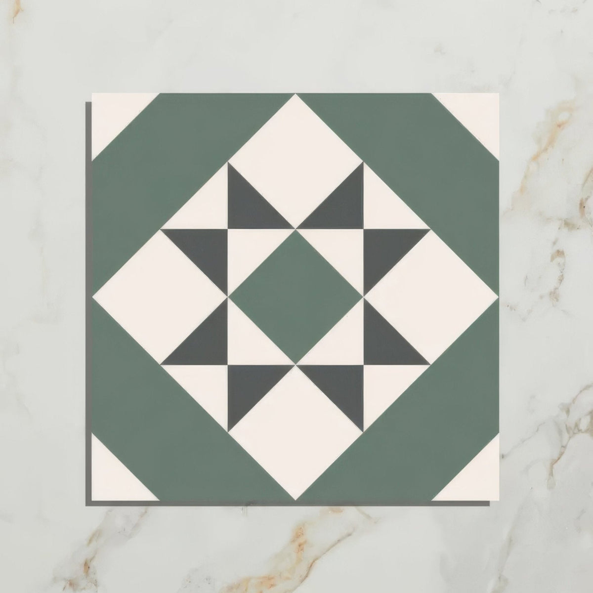 A square brompton porcelain greenwich mosaic tile with a geometric star pattern in sage green black and off-white