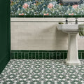 White porcelain brompton greenwich pedestal sink with chrome faucets and green towel draped over side