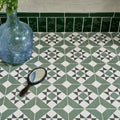 A brompton porcelain greenwich vintage-style hand mirror with a dark wooden handle and oval reflective surface
