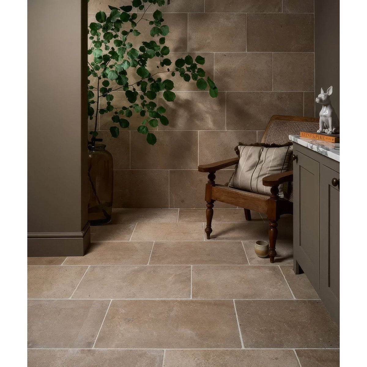Beige rectangular buscot blend limestone tiles with tumbled finish and subtle natural variations with light grout lines