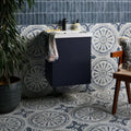 Navy blue floating bathroom vanity with white ceramic matt countertop and two drawers in canero style