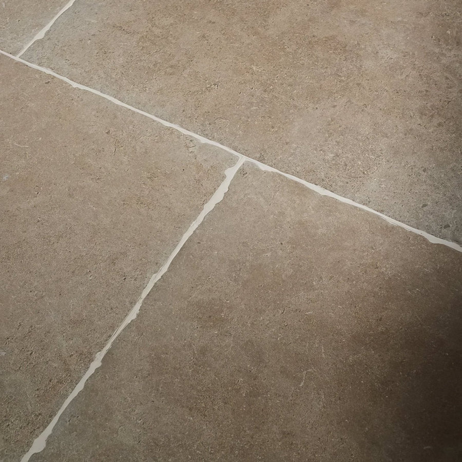 Beige cotswold porcelain matt stone tiles with subtle texture and white grout lines for flooring and walls