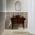 Dark wood vanity with two doors and ornate metal handles topped by polished marble surface in cotswold porcelain matt