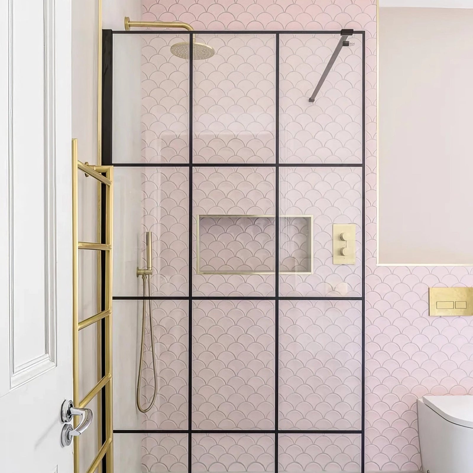 Gelato Porcelain Mosaic Cotton Candy pink scalloped porcelain mosaic with a gold-framed glass shower enclosure