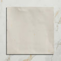 A square off-white hammam ceramic white tile with subtle marbling and minor surface stains on a ceramic material