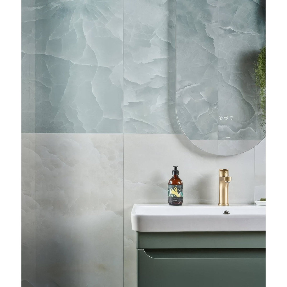 illusion Whisper Onyx Porcelain Polished Lagoon pale green marble-effect tiles with a sink and green cabinet