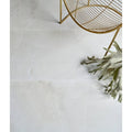 White marble-effect illusion Whisper Onyx polished porcelain floor tiles with subtle veining in mist color