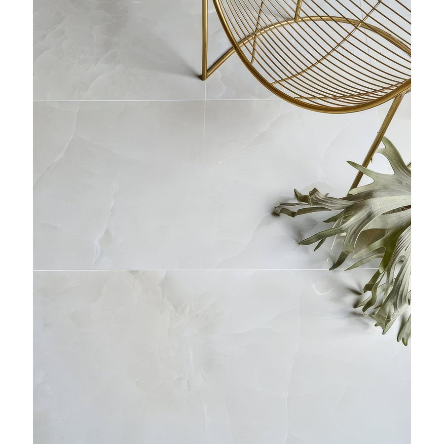 White marble-effect illusion Whisper Onyx polished porcelain floor tiles with subtle veining in mist color