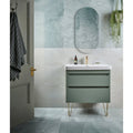 illusion Whisper Onyx Porcelain Polished Mist white marble-effect tiles with a sage green vanity