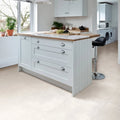 Light gray shaker-style kitchen island with marble countertop and silver round knobs in loft porcelain pearl 60 x 60cm