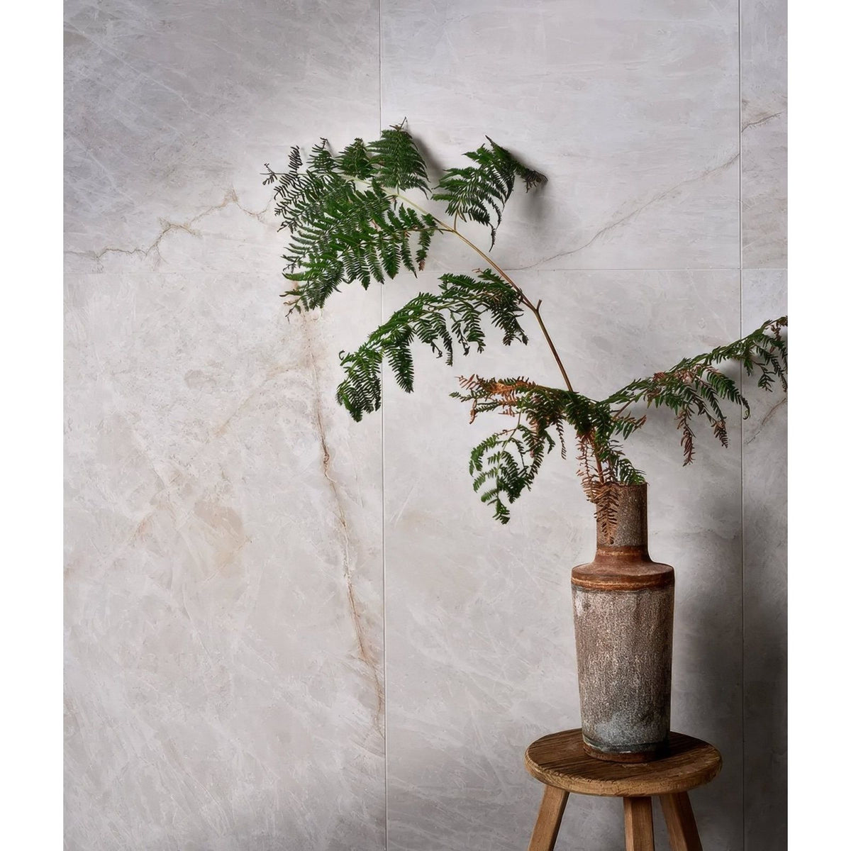 Manhattan Porcelain Matt grey marble-effect porcelain tiles with a ceramic vase and fern