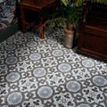 Orleans ceramic matt vinyl floor tiles with vintage circular motifs in shades of gray and blue on white background