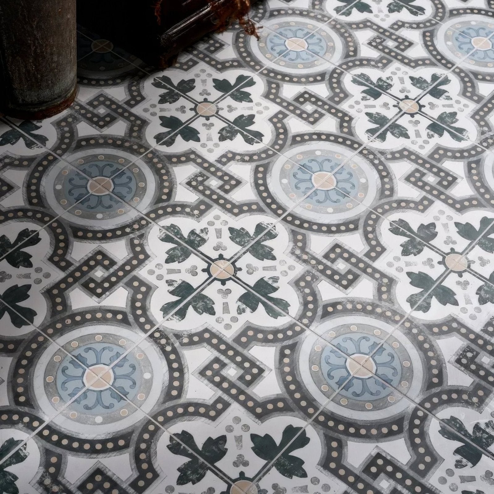 Orleans ceramic matt vintage-style mosaic floor tiles with intricate black gray and muted blue floral patterns on white