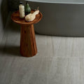 A rustic wooden side table pembroke porcelain satin 60 x 60cm with round top tapered legs and warm brown tones