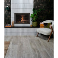 Modern fireplace with black frame and visible flames set into white vertical parterre porcelain plank subway tiles
