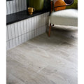 Gray wood-grain vinyl plank flooring with natural textured finish in parterre porcelain plank design
