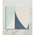 A square rio porcelain tile with a modern abstract design in pastel mint green cream and navy blue separated by curved lines