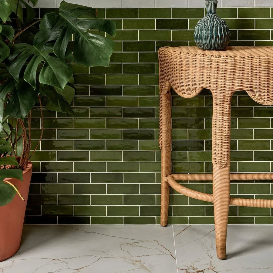 Soprano Porcelain 60 x 60cm cream marble-effect tiles with a green ceramic vase on a wicker table