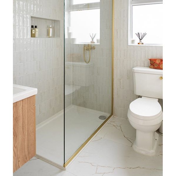 Soprano Porcelain cream marble-effect tiles with a glass shower enclosure