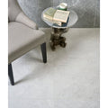 Tribeca Porcelain Blanco 60 x 120cm white marble-effect tiles with a bronze monkey side table
