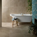 Winchester Porcelain Satin 60 x 60cm beige stone-effect porcelain tiles with a freestanding bathtub