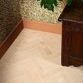 Beige herringbone patterned portland limestone honed parquet floor tiles with natural stone texture