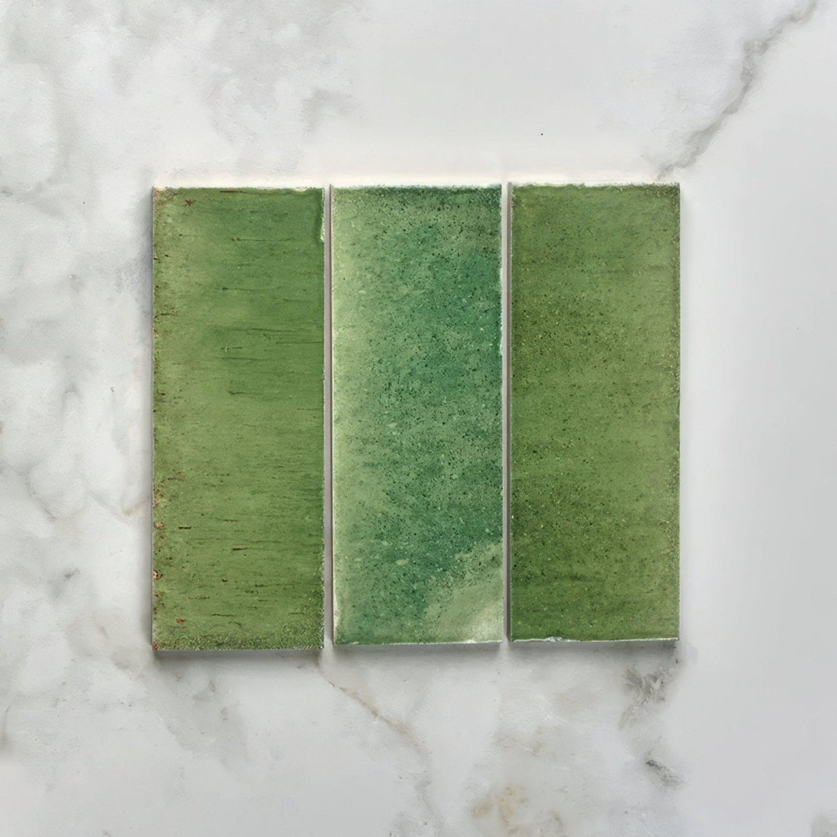 Three rectangular green pottery porcelain tiles with textured matte finish arranged side by side for brick use