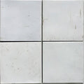 White square porcelain tiles with subtle gray speckles and minor surface scratches from pottery porcelain natural cotton square collection