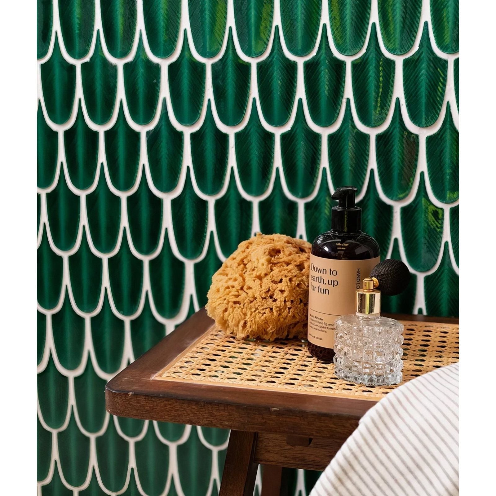 Dark green glossy ceramic tiles with white outlines form scalloped leaf pattern in preen porcelain mosaic emerald wall tiles
