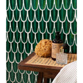 Dark green glossy ceramic tiles with white outlines form scalloped leaf pattern in preen porcelain mosaic emerald wall tiles