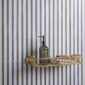 Promenade Brighton 60x30cm gold-toned wire shower caddy with a modern design holding a dark glass soap dispenser and towels