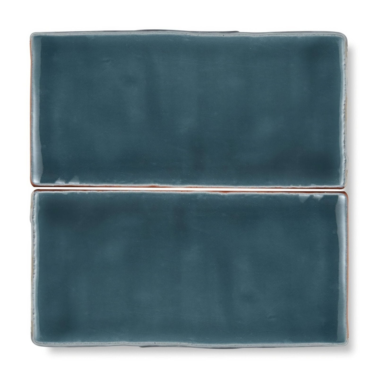 Two teal ceramic Provence Aspremont Rectangle tiles with matte finish and rustic uneven edges for wall or floor use