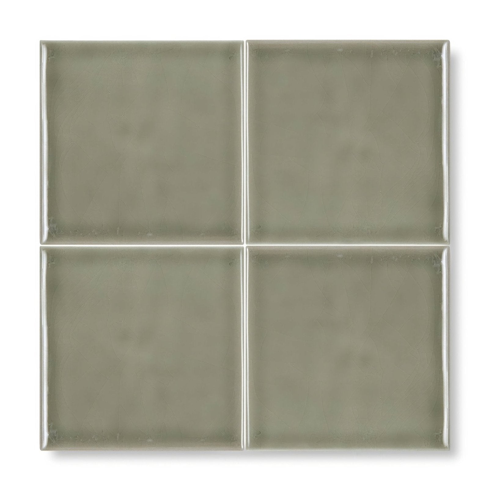 Provence cabris square glass tile with a matte sage green finish divided by thin metallic grout lines