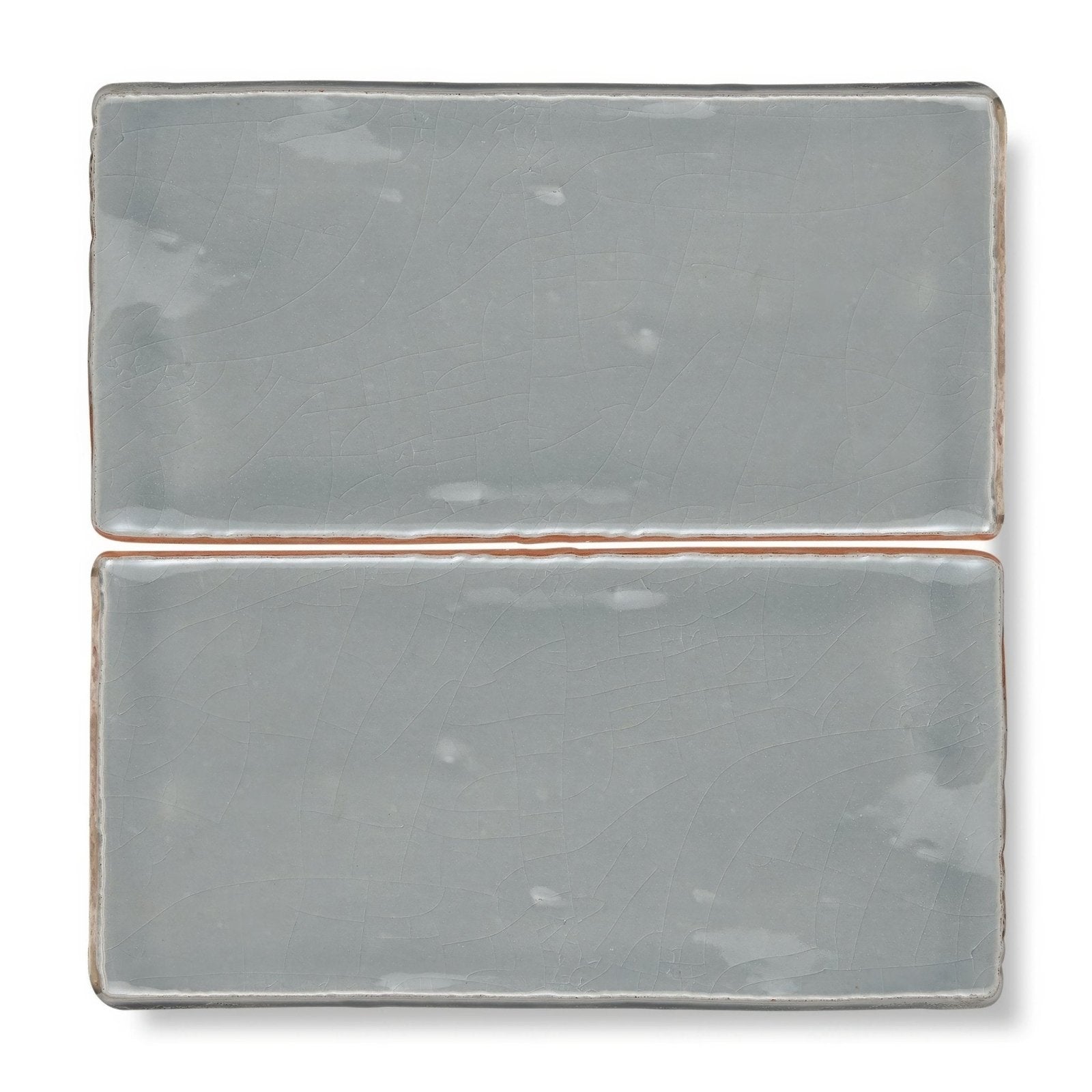 Two rectangular ceramic tiles with matte muted gray glaze and slightly uneven edges from provence falicon rectangle collection