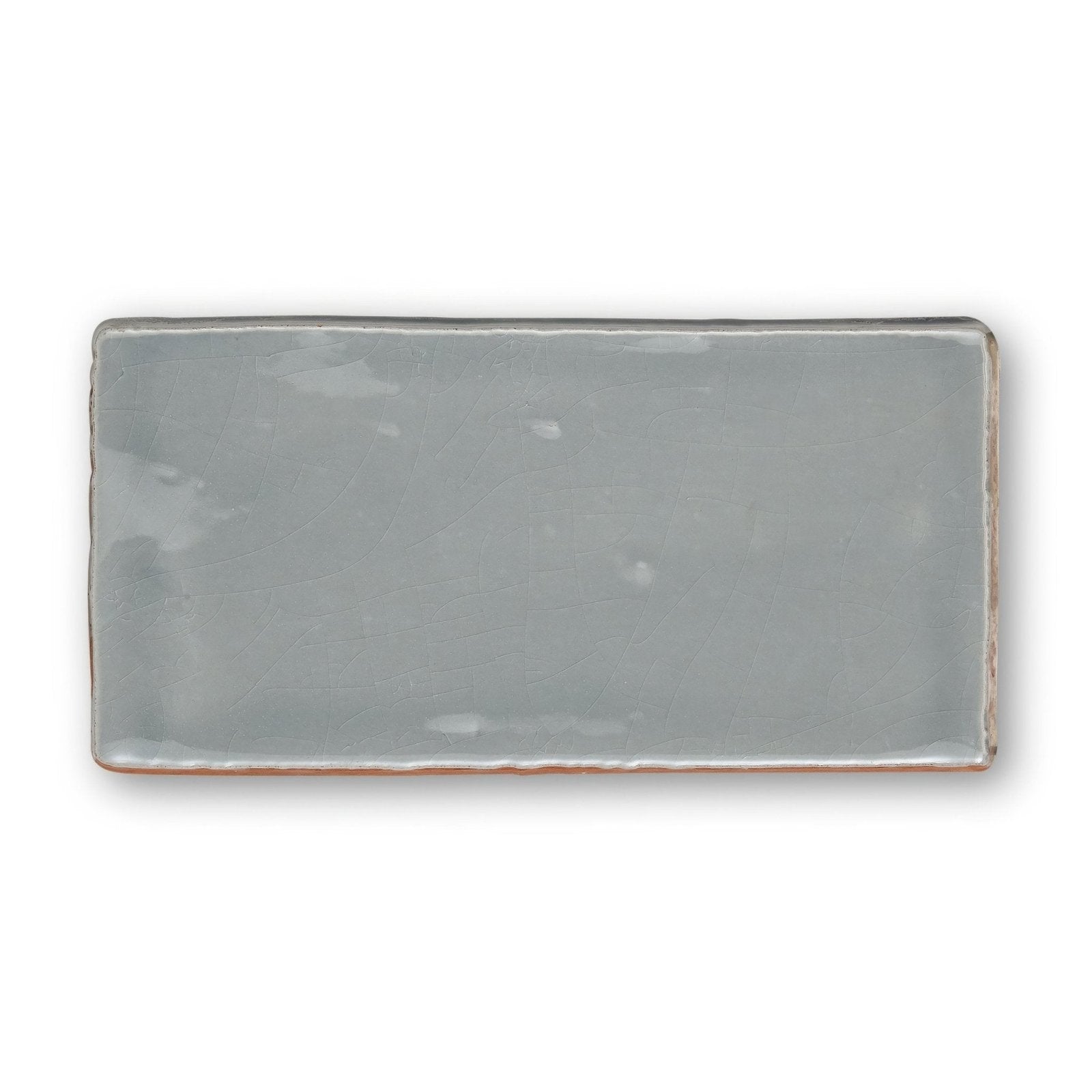 A rectangular ceramic tile provence falicon rectangle with a matte muted gray glaze and slightly uneven edges
