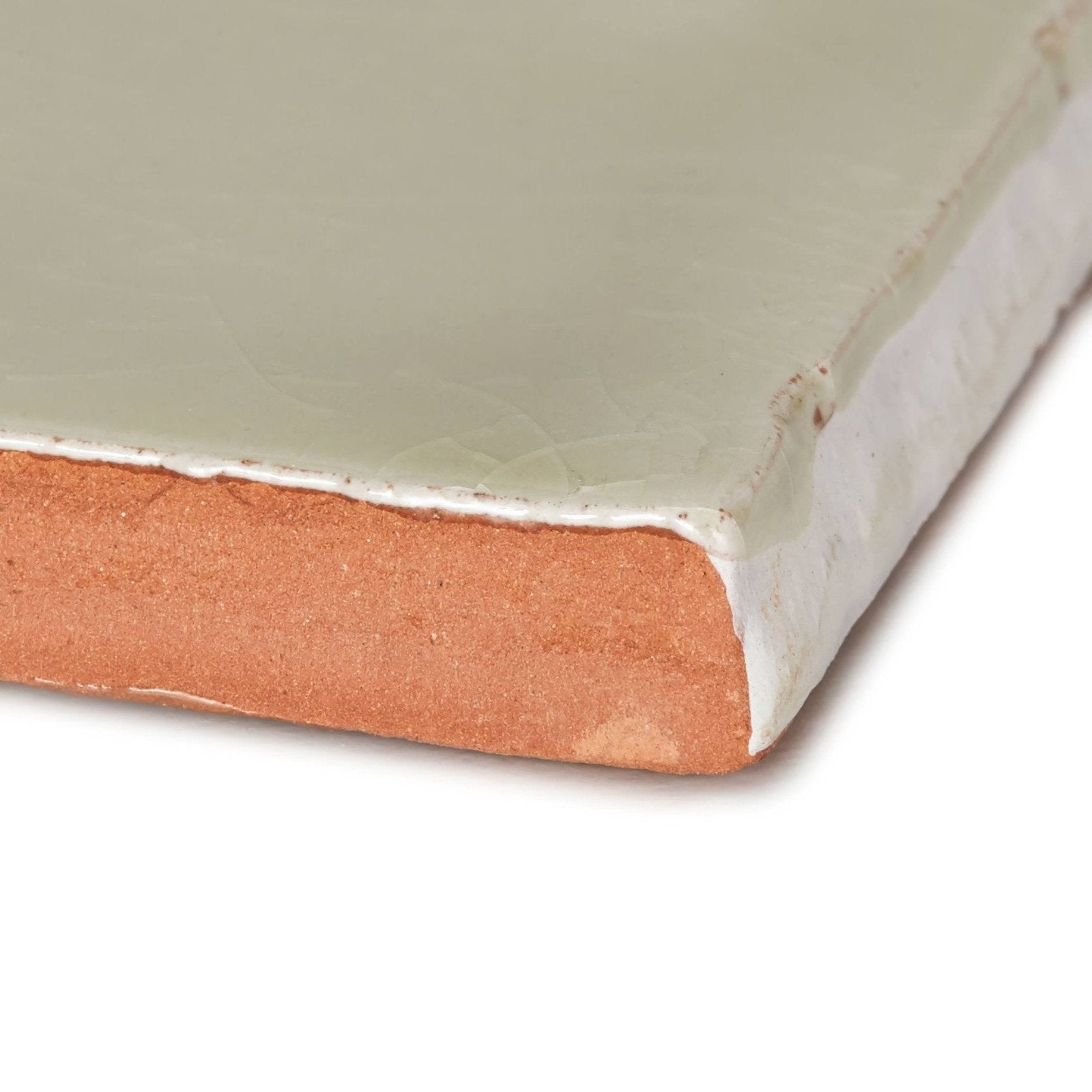 A Provence Miramar rectangle ceramic tile with matte pale green glaze and visible terracotta clay edge
