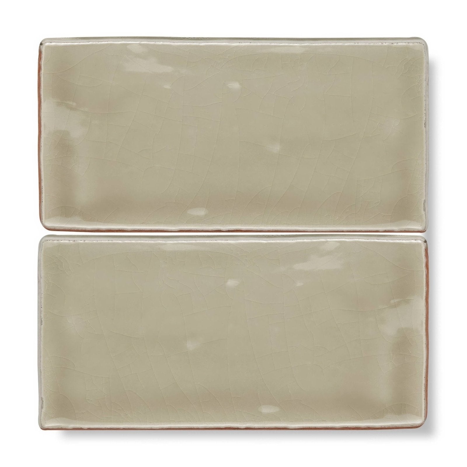 Two rectangular ceramic tiles with matte muted beige glaze and slightly uneven edges from Provence Miramar rectangle collection