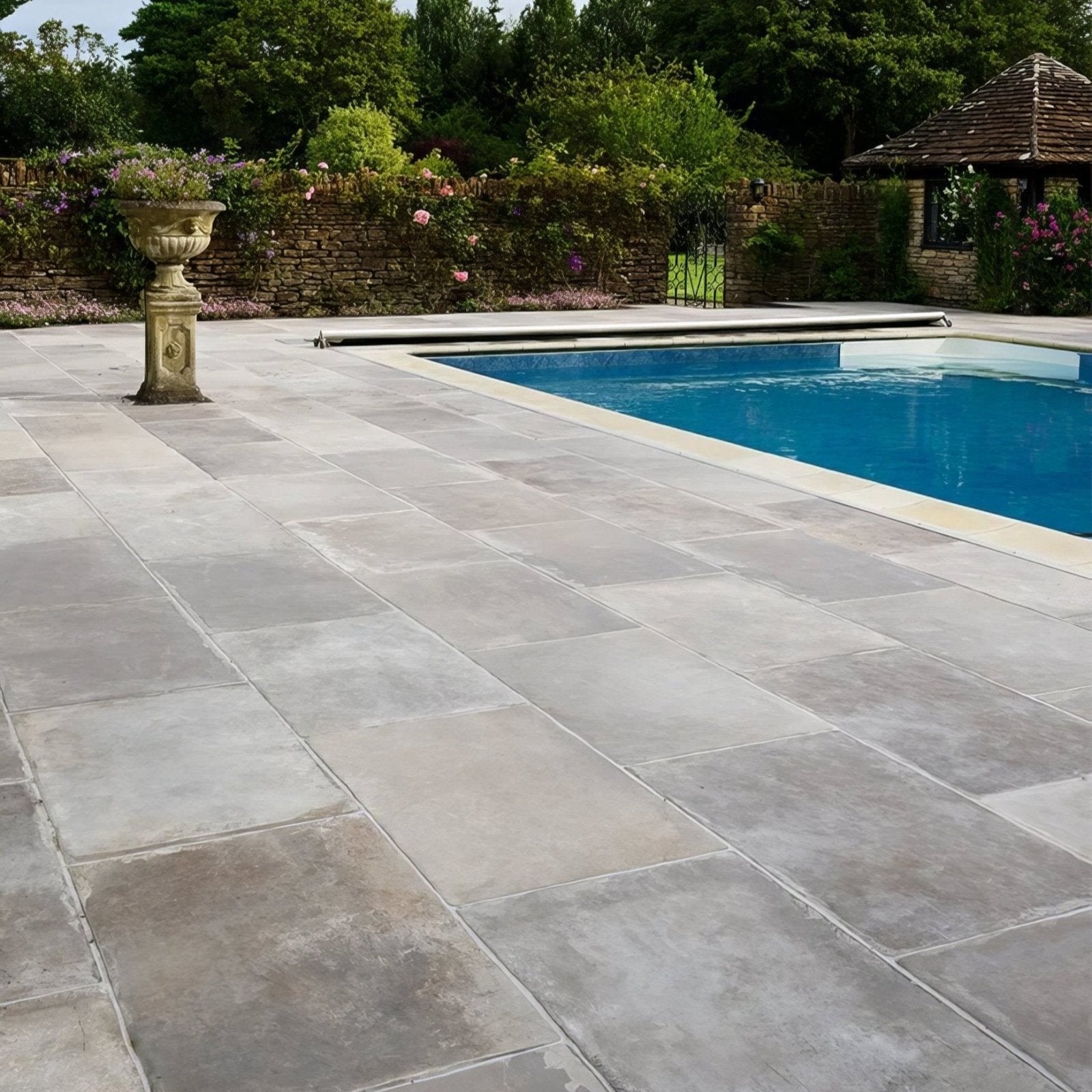 Gray stone patio tiles with subtle natural texture and slight tone variations in provence paving porcelain cenere