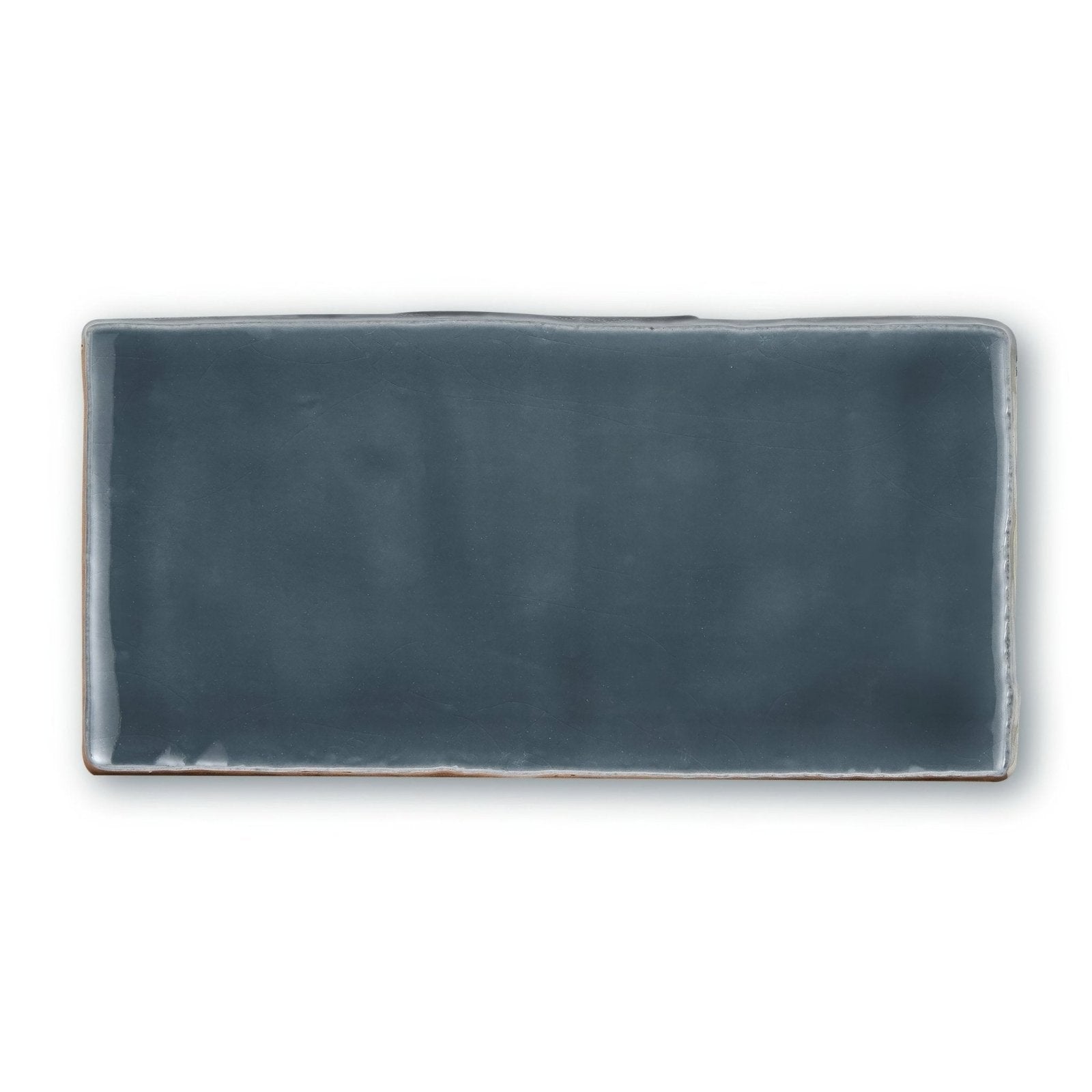 A rectangular ceramic tile in matte slate gray with slightly uneven edges from provence peillon rectangle collection