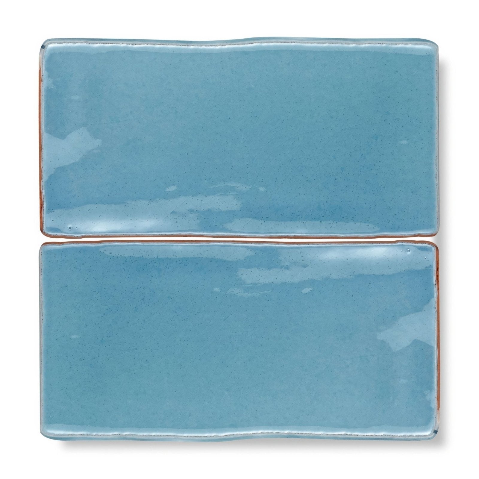 Two rectangular ceramic tiles with glossy light blue glaze and uneven edges from provence turbie rectangle collection