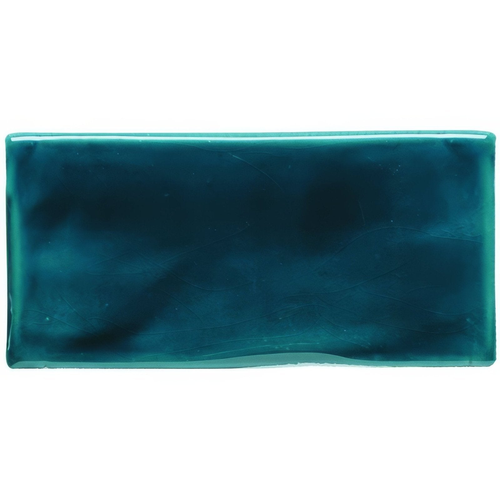 A rectangular teal prussian blue half tile ceramic with a glossy gradient finish from deep to lighter shades