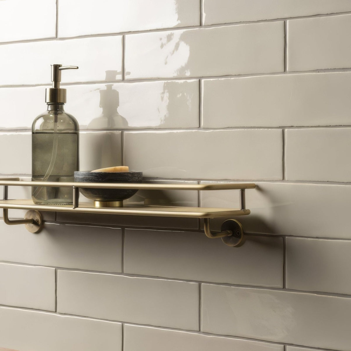 Pumice Large Brick Tile beige brick tiles with a brass shelf and soap dispenser