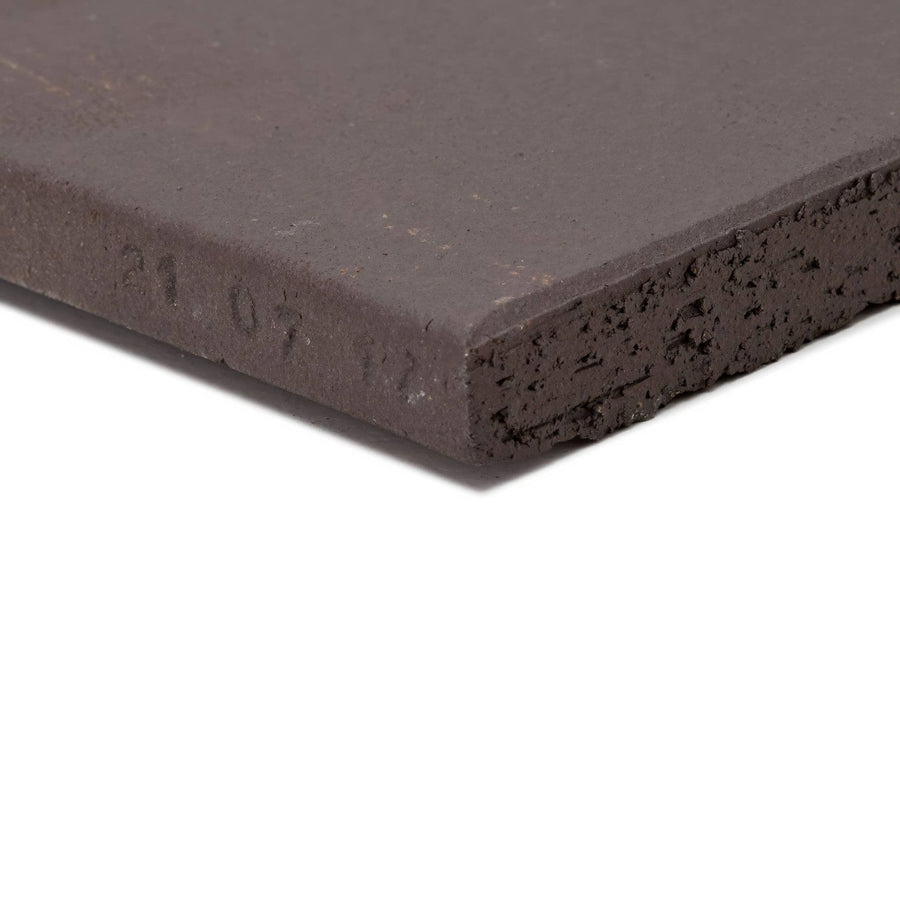 Dark gray quarry black square tile with textured porous surface and slightly chipped edges for flooring and walls