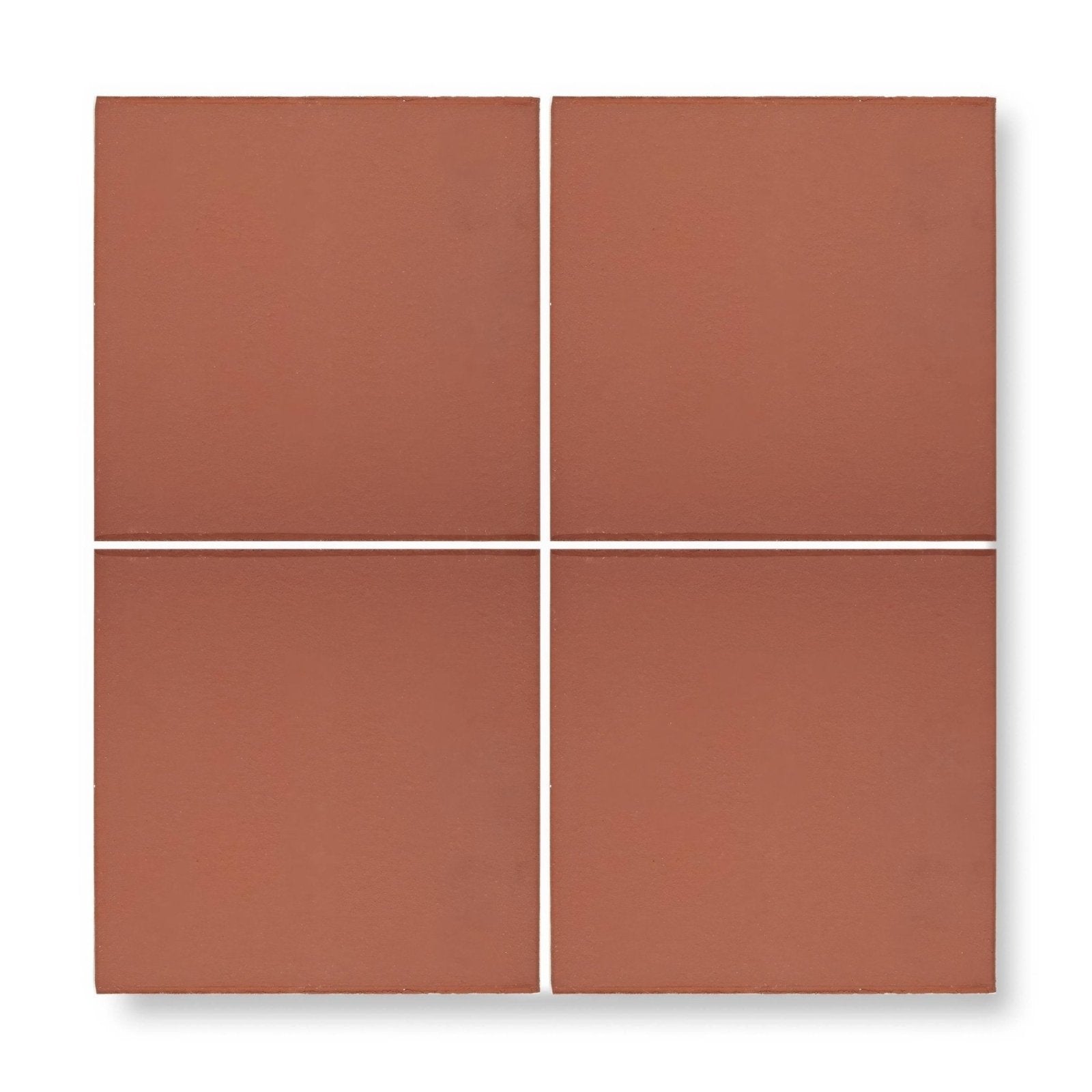 Four square quarry red terracotta tiles with a matte finish and uniform reddish brown color arranged in a grid