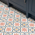 Quintessential porcelain Salisbury patterned ceramic floor tiles with intricate orange yellow black and muted green designs on white background