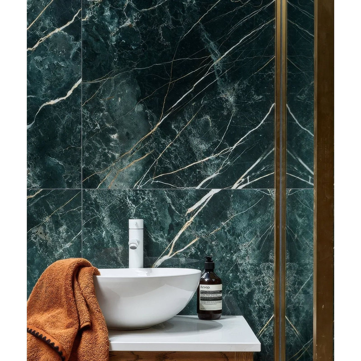 Rainforest Porcelain Malachite dark green marble-effect tiles with a white bowl sink